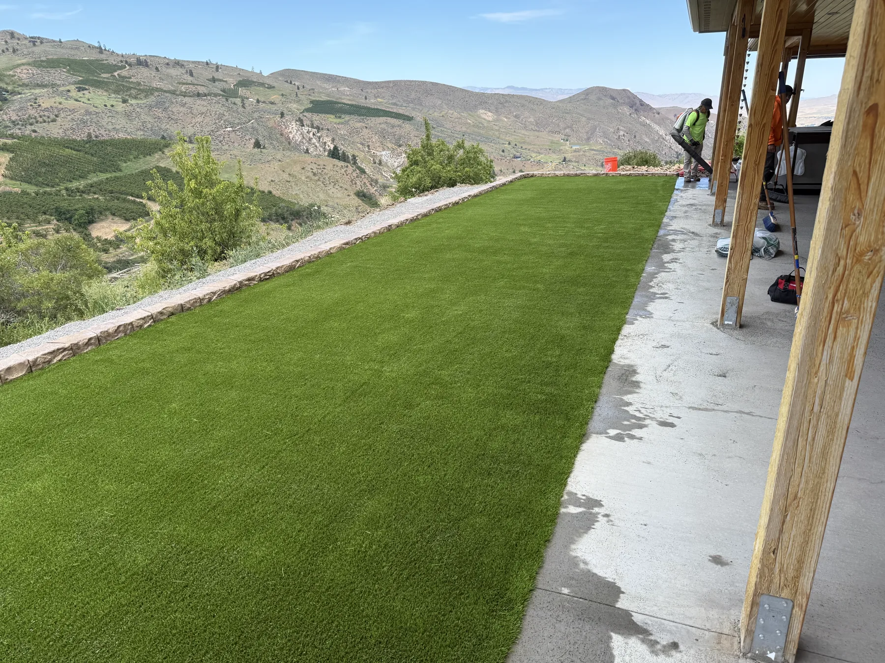 Artificial turf lawn off a covered patio with hillside views