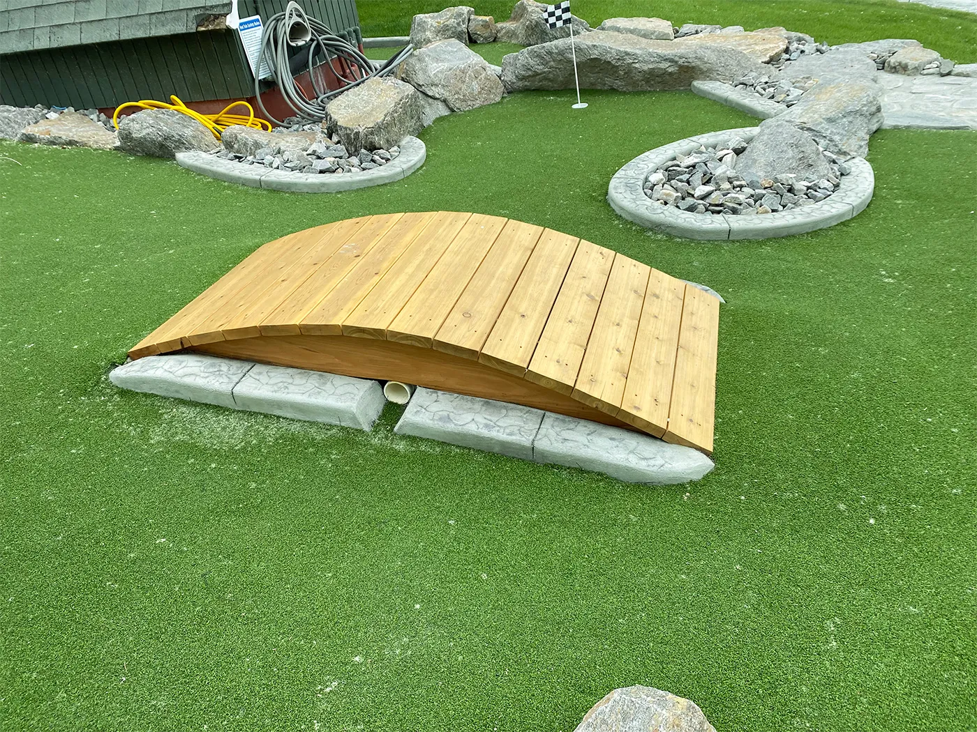 Wooden bridge through a landscaped putting course