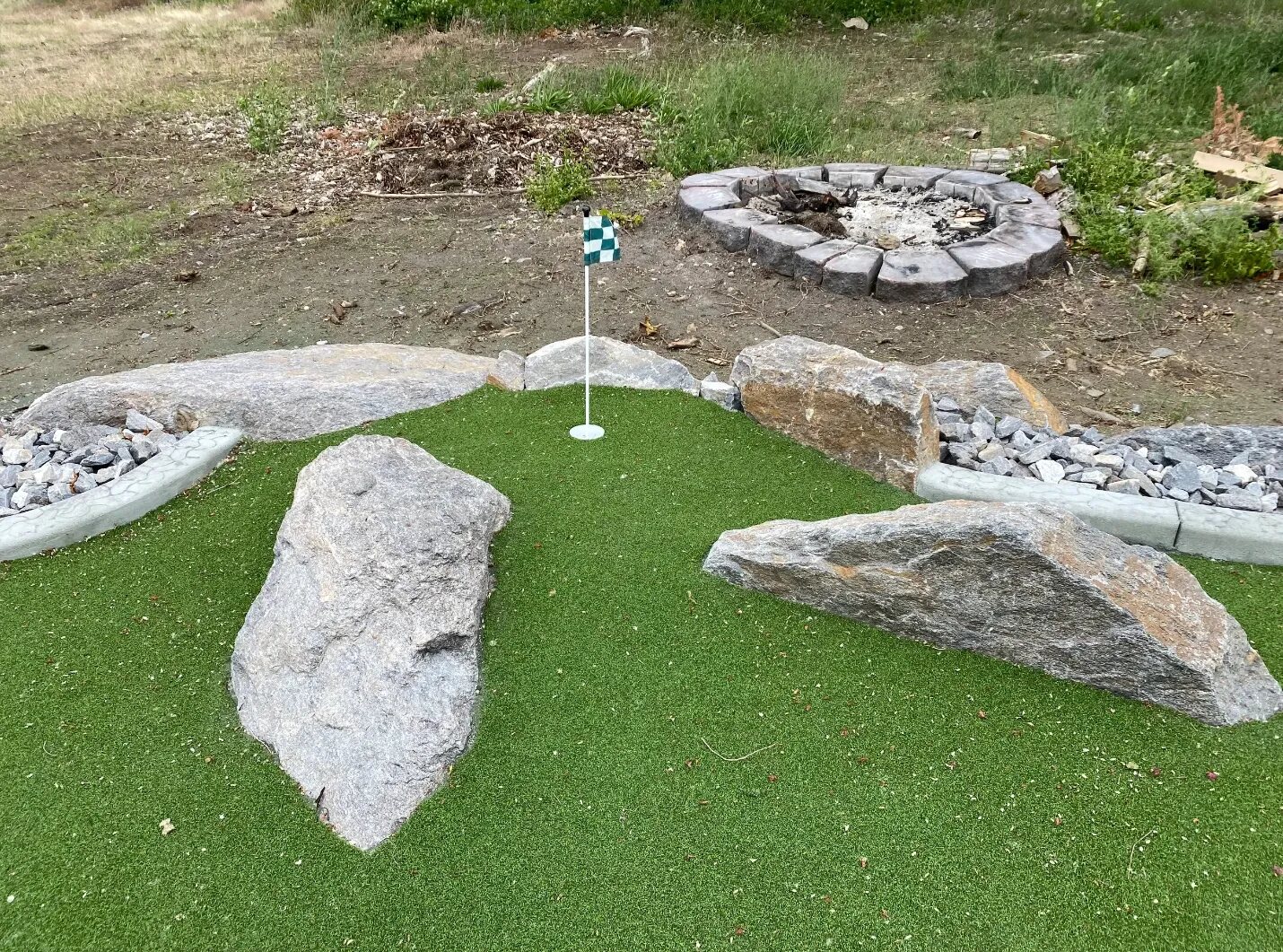 Custom backyard putting green built by C&E Landscaping