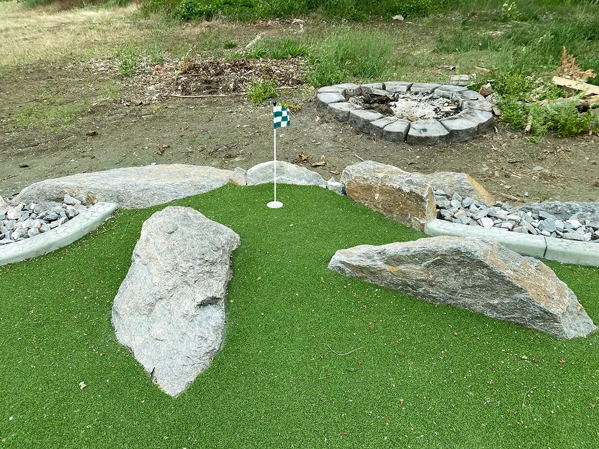 Putting green with boulders and flag