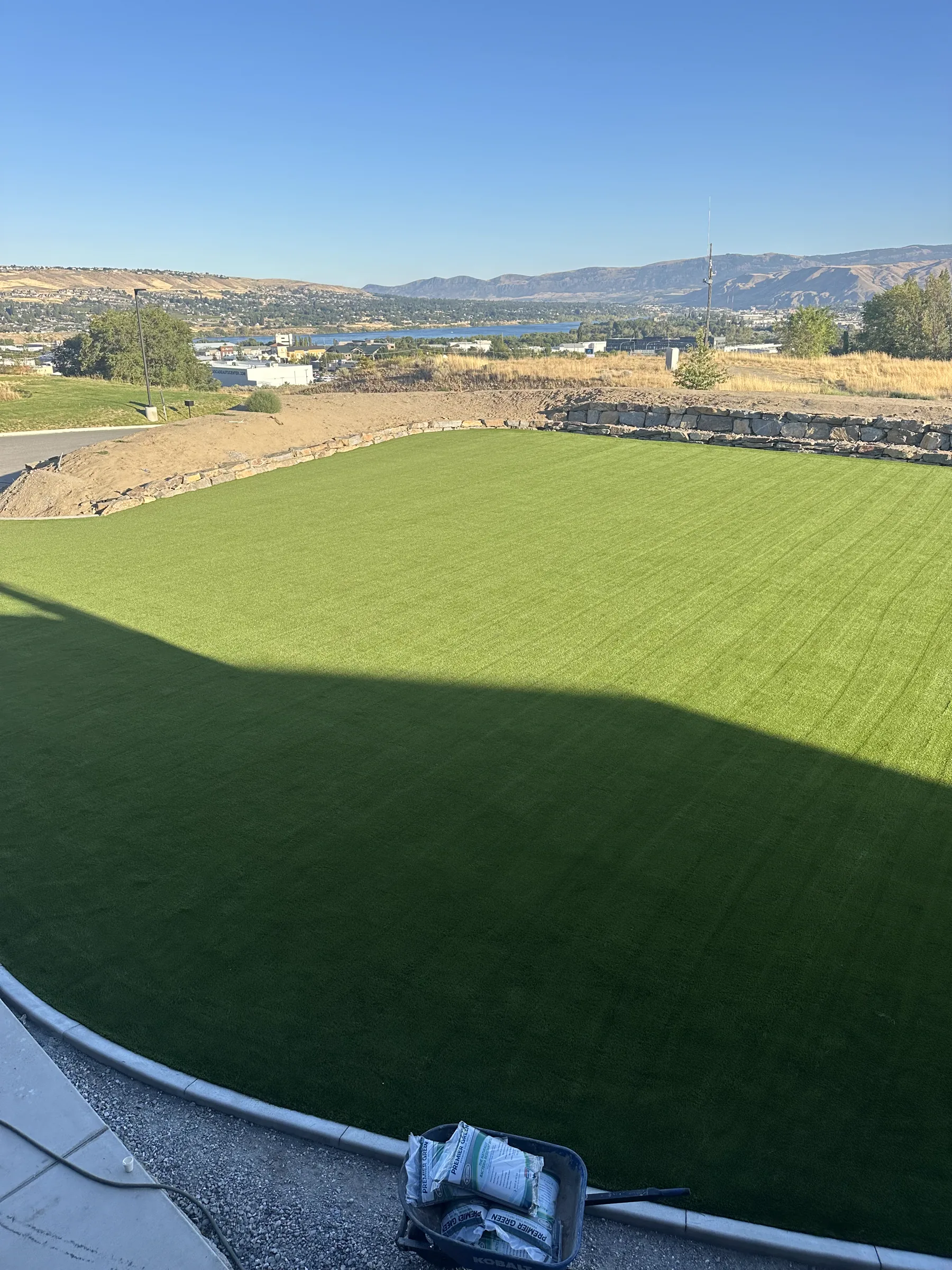 Large terraced artificial turf lawn overlooking the valley