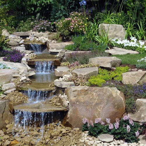 Waterfall surrounded by flowers